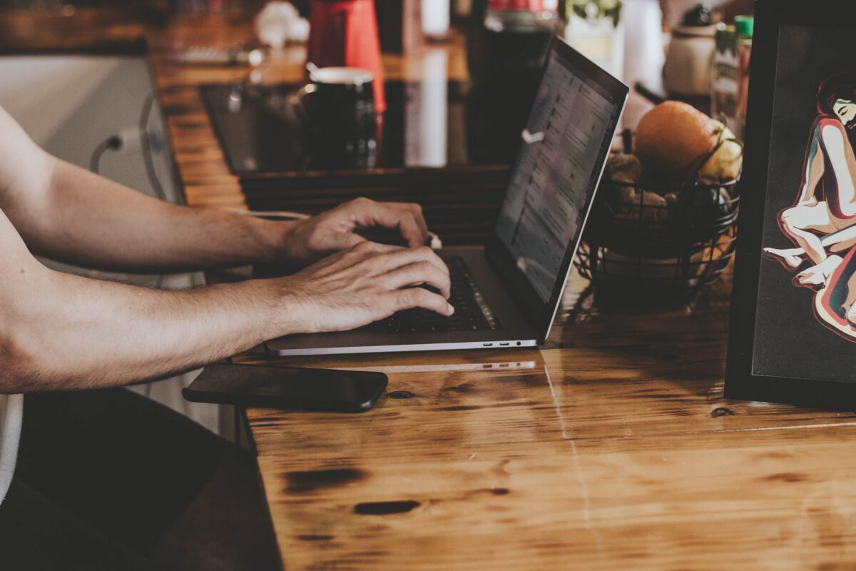 person typing at their computer