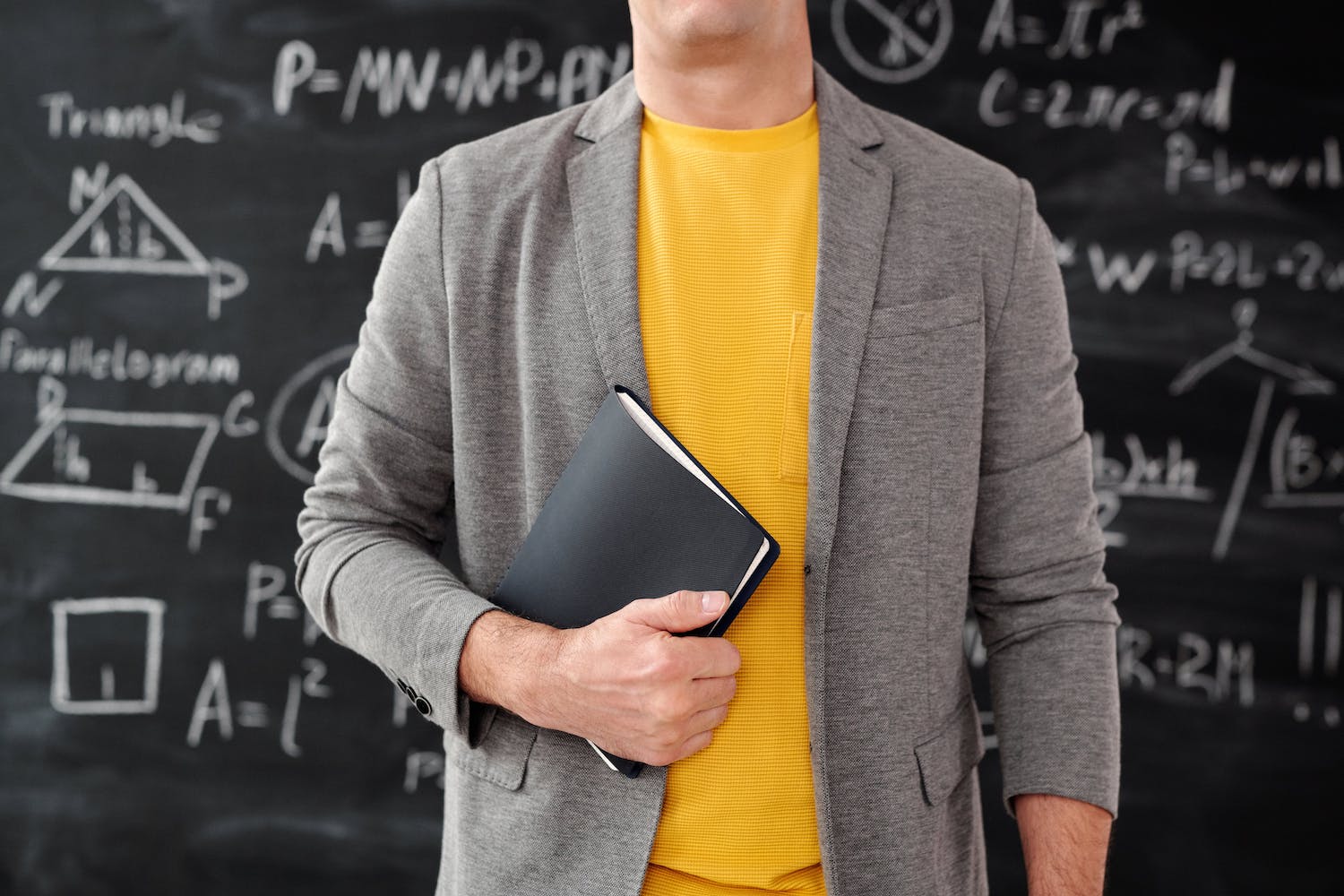 teacher in front of chalk board